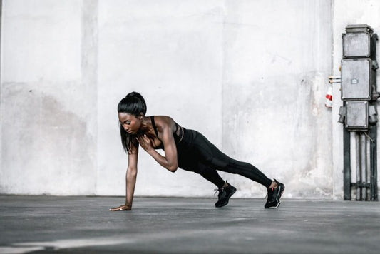Woman performing a plank exercise showcasing strength in 10 Quick Exercises for Home
